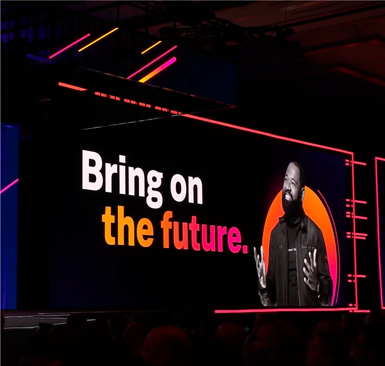 Graphic of a typography specimen showing the alphabet and numerals on top of a dark gray background.